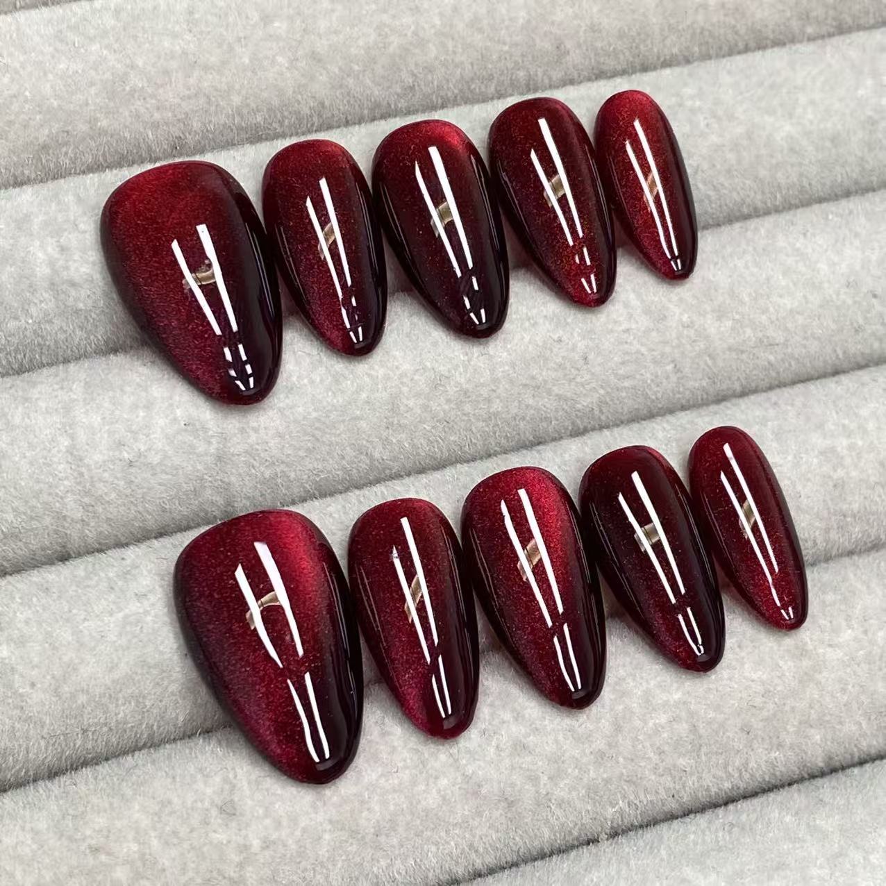 Cool and sophisticated black base with burgundy cat-eye design, almond-shaped handmade nails - RT