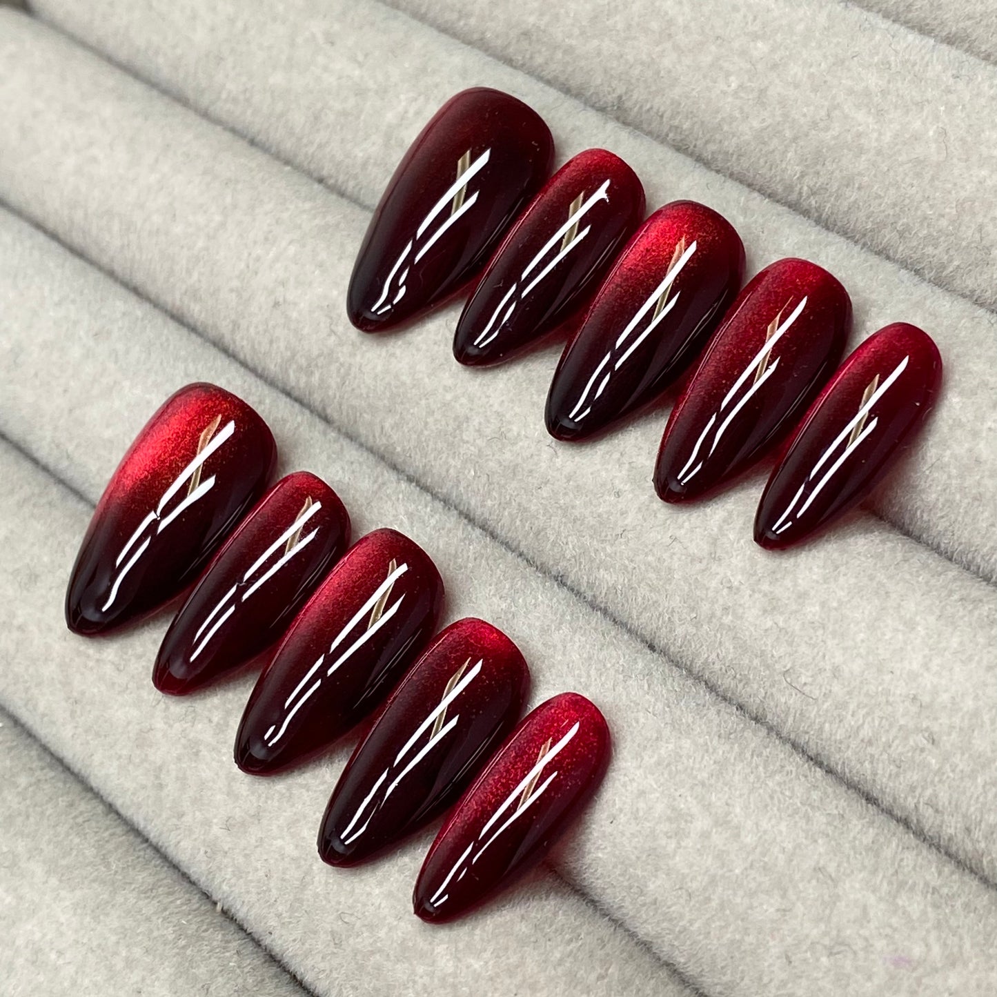 Cool and sophisticated black base with burgundy cat-eye design, almond-shaped handmade nails - RT