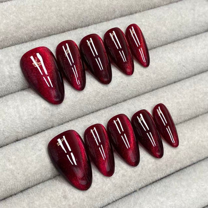 Cool and sophisticated black base with burgundy cat-eye design, almond-shaped handmade nails - RT