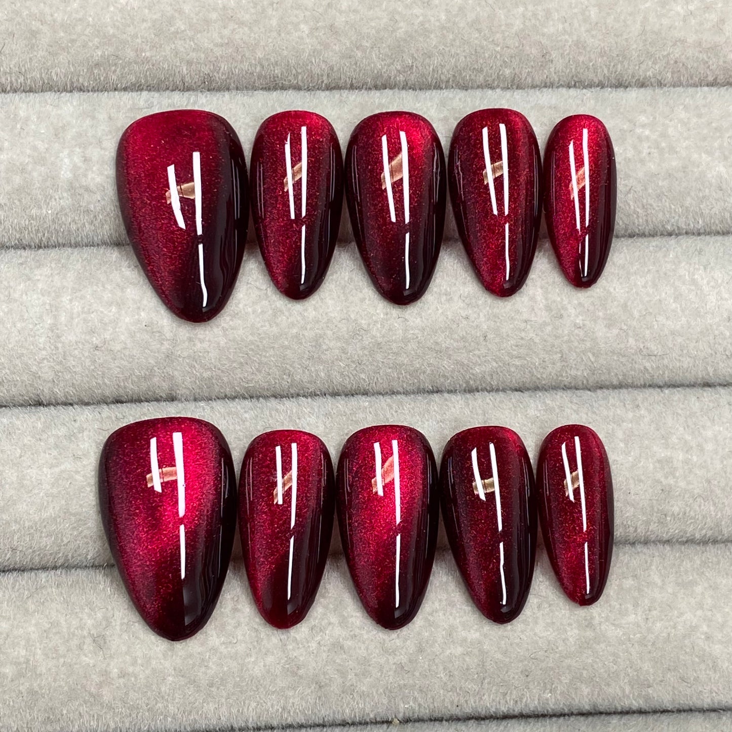 Cool and sophisticated black base with burgundy cat-eye design, almond-shaped handmade nails - RT