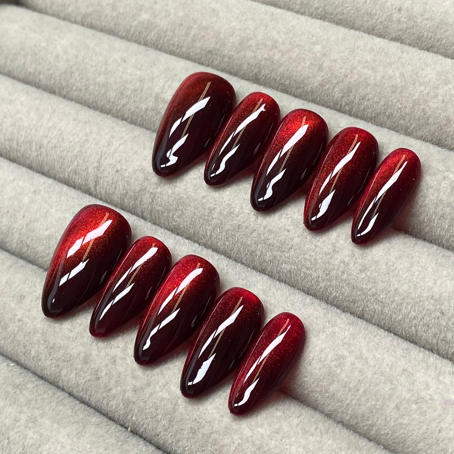 Cool and sophisticated black base with burgundy cat-eye design, almond-shaped handmade nails - RT
