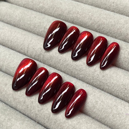 Cool and sophisticated black base with burgundy cat-eye design, almond-shaped handmade nails - RT